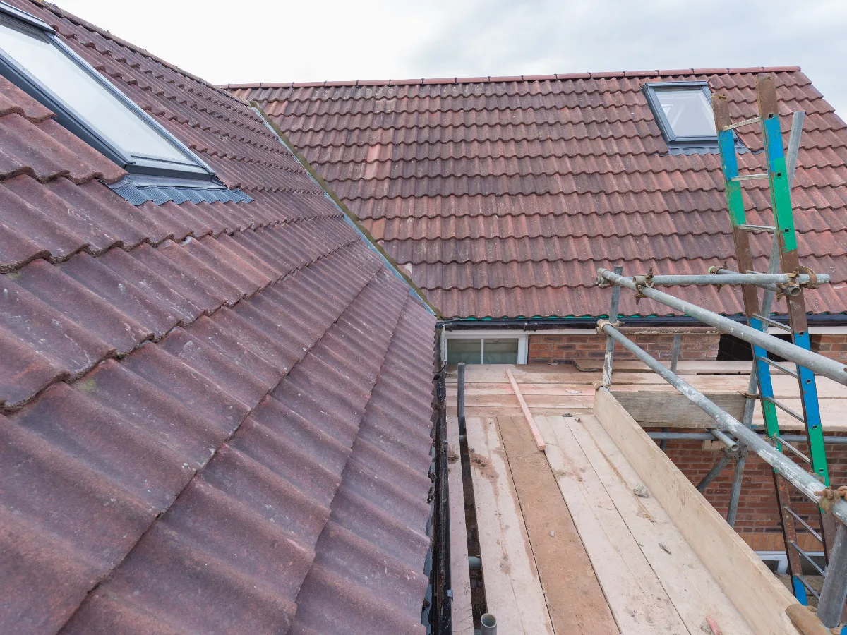 Tiled roof with scaffold and roof window