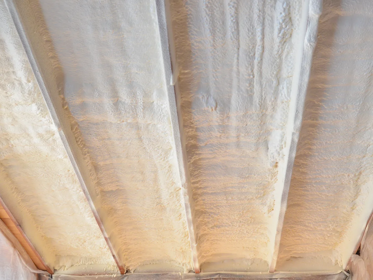 Spray foam insulation on the underside of roof rafters